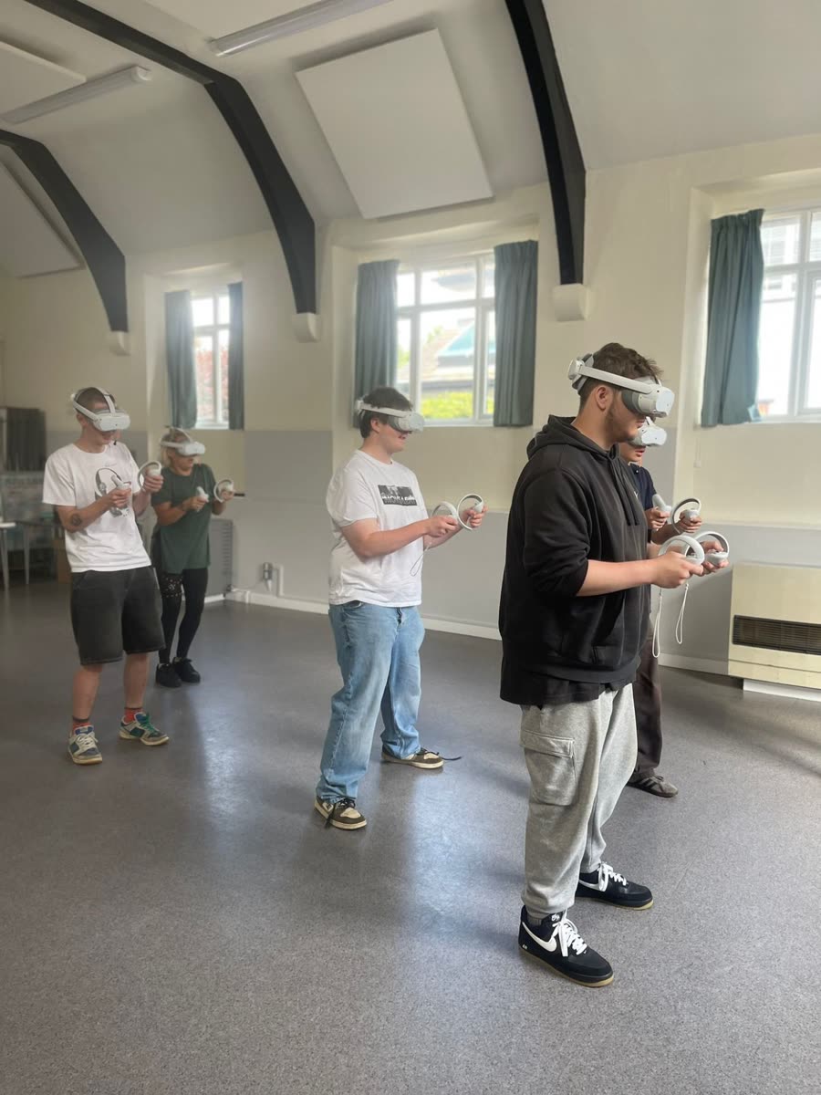 Six players in VR headsets playing together in a community hall